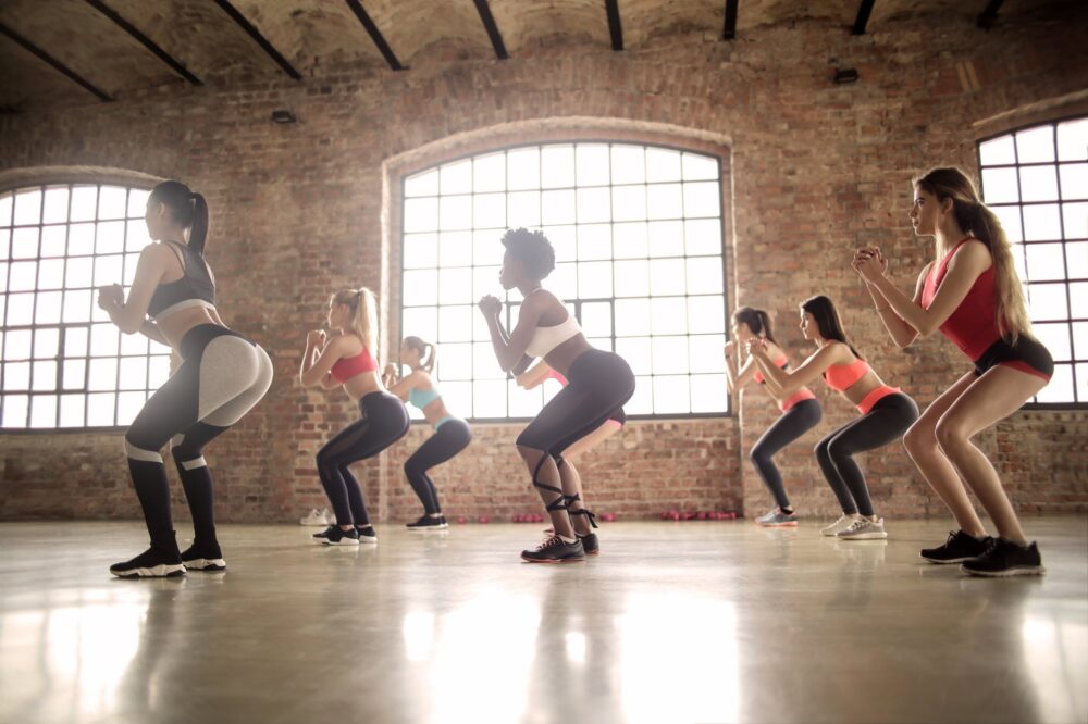 women doing squat exercise